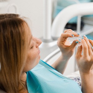 Closeup of patient holding clear aligner