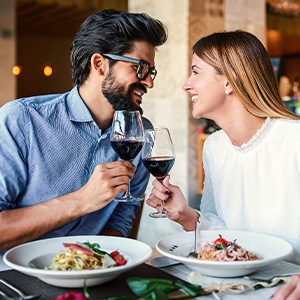 Couple smiling at each other on date in restaurant