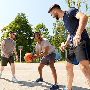 Group of friends playing basketball outside