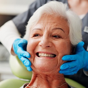 A woman smiling at the dentist