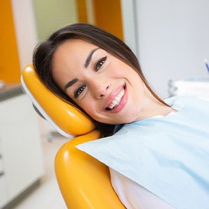 Woman smiling while sitting in treatment chair