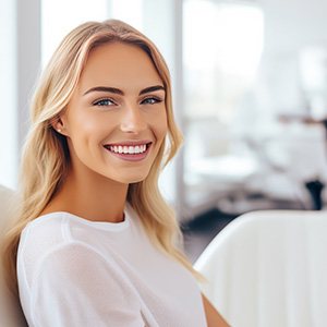 Woman smiling while sitting in treatment chair
