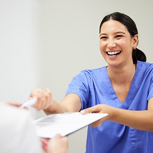 Patient in Rowlett filling out paperwork for braces