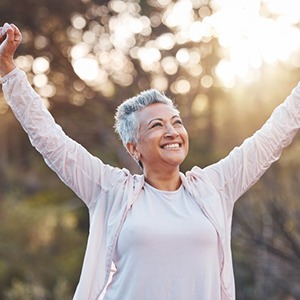 a woman smiling and exercising outside