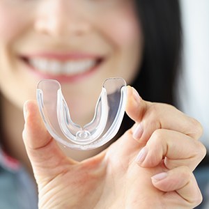 Patient holding mouthguard
