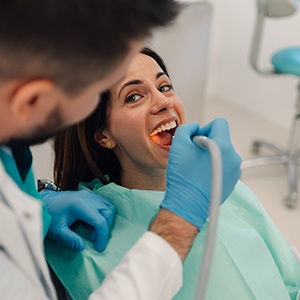 Dentist in Rowlett examining dental implants during checkup