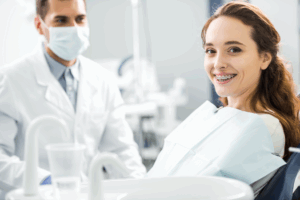 a young patient with braces smiling