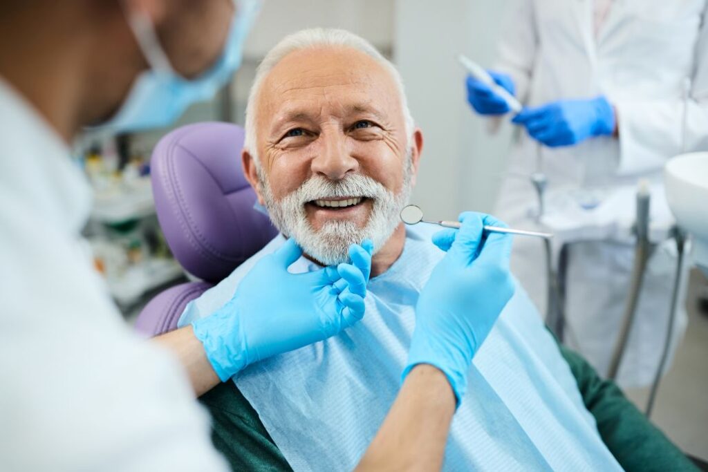 A man at a denture check up with his dentist.