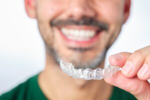 Man holding an Invisalign tray